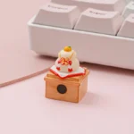 Close-up of a handcrafted Kagami Mochi keycap from the product gallery, showcasing its intricate stacked mochi design and vibrant orange accent.