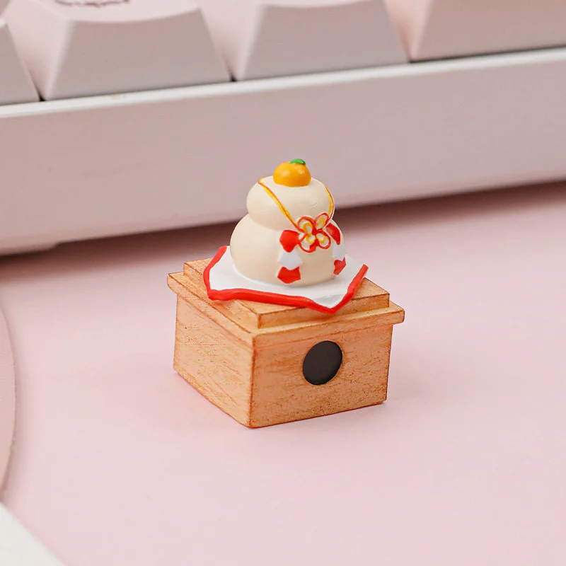 Handcrafted Kagami Mochi keycap close-up, revealing its unique stacked mochi design and symbolic orange details from various artistic angles.