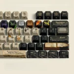 Detailed gallery views of the Book of Potions Magic Keycap Set, displaying mystical alchemical symbols and ancient lore, embodying its exclusive arcade.