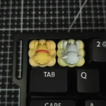 Detailed shot of an adorable handcrafted resin dog keycap, showcasing its unique minimalist line art pet design enjoying a tranquil spa moment with playful keycaps.