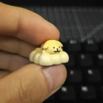 Close-up of an adorable handcrafted resin dog keycap, featuring minimalist line art of a pet enjoying a tranquil spa moment, perfect for mechanical keyboard.
