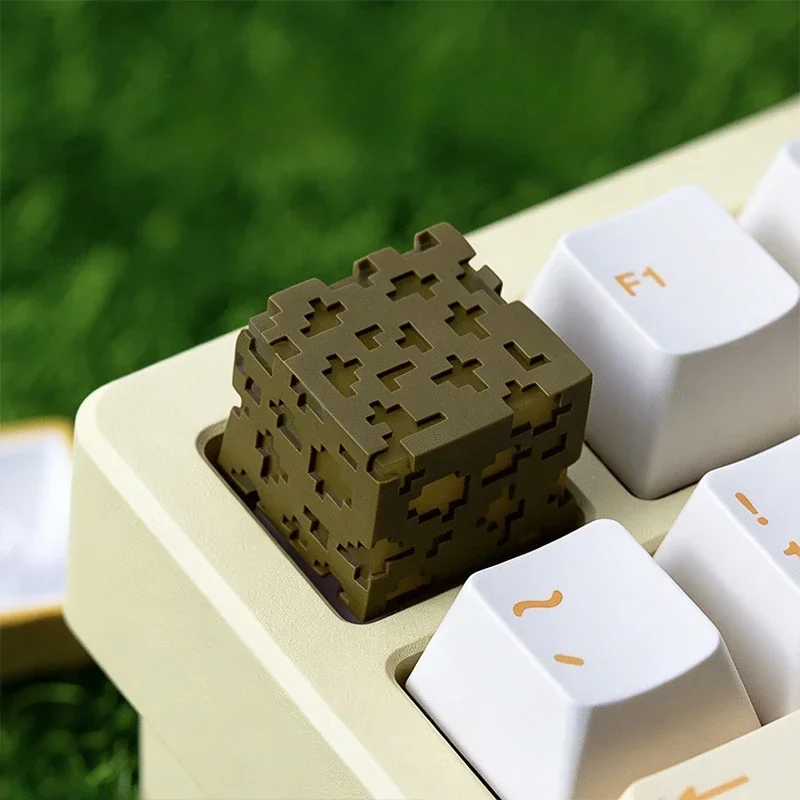 Iconic Minecraft Glowstone Keycap crafted from translucent resin, captured at an engaging angle, highlighting its unique pixelated glow on a gaming keyboard.