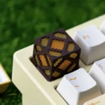 Close-up of a handcrafted resin Minecraft Glowstone keycap, showing its iconic pixelated design and translucent, glowing effect on a gaming keyboard.