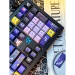 Premium Overwatch Moira PBT dye-sub keycap set, displayed from various angles, highlighting its sophisticated, dark, and futuristic gaming design.