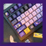 Multiple angles of the premium PBT dye-sublimated Overwatch Moira keycap set, highlighting its futuristic, sophisticated dark aesthetic for immersive.