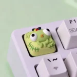 Whimsical PEAK Bing Bong artisan keycap in a gallery, highlighting its vibrant hand-painted sculpted character and intricate details for unique keyboard.