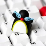 Handcrafted Pingu artisan keycap, detailed from various angles. Vibrant, whimsical claymation scenes bring nostalgic keyboard charm and playful art.