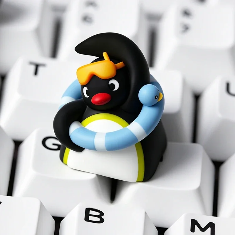 Handcrafted Pingu resin artisan keycap, shown from a playful side angle, revealing vibrant claymation details and whimsical charm for a nostalgic keyboard.
