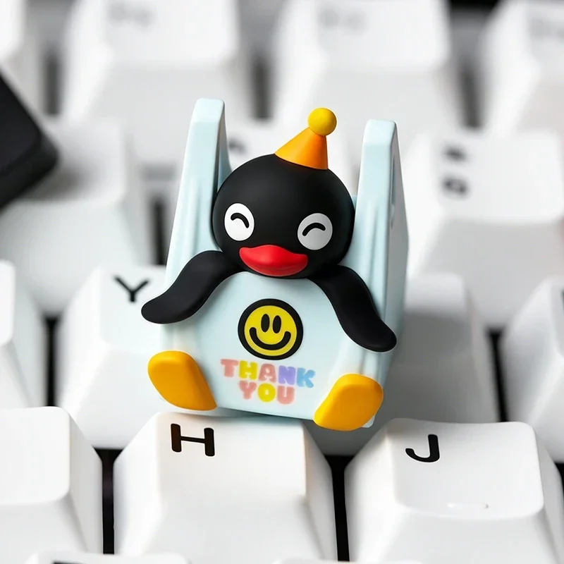 Handcrafted Pingu resin artisan keycap, shown from a unique angle. Its vibrant colors and whimsical details capture nostalgic claymation charm for your keyboard.