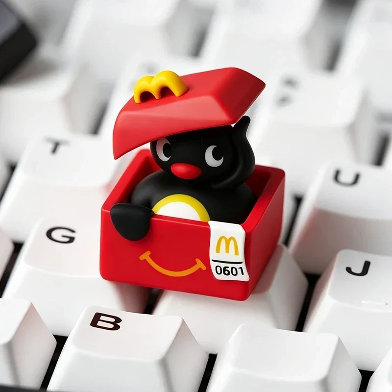 Close-up of a handcrafted Pingu resin artisan keycap, showcasing its whimsical details and vibrant colors, perfect for a nostalgic keyboard charm.