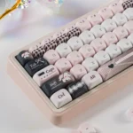 Close-up of pastel pink bandage puppy keycaps from multiple angles, showcasing the whimsical design and MOA profile for mechanical keyboards.