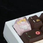 Close-up of a whimsical handcrafted resin snowman artisan keycap, showcasing its intricate details and playful design from multiple angles.