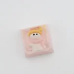 A whimsical handcrafted resin snowman artisan keycap, intricately sculpted, seen from a fresh angle, showcasing its adorable details.