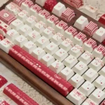 Unique Raspberry Mousse PBT Dye-Sub keycaps set from a close-up angle. Their playful, soft berry offer a sweet, comforting dessert aesthetic.