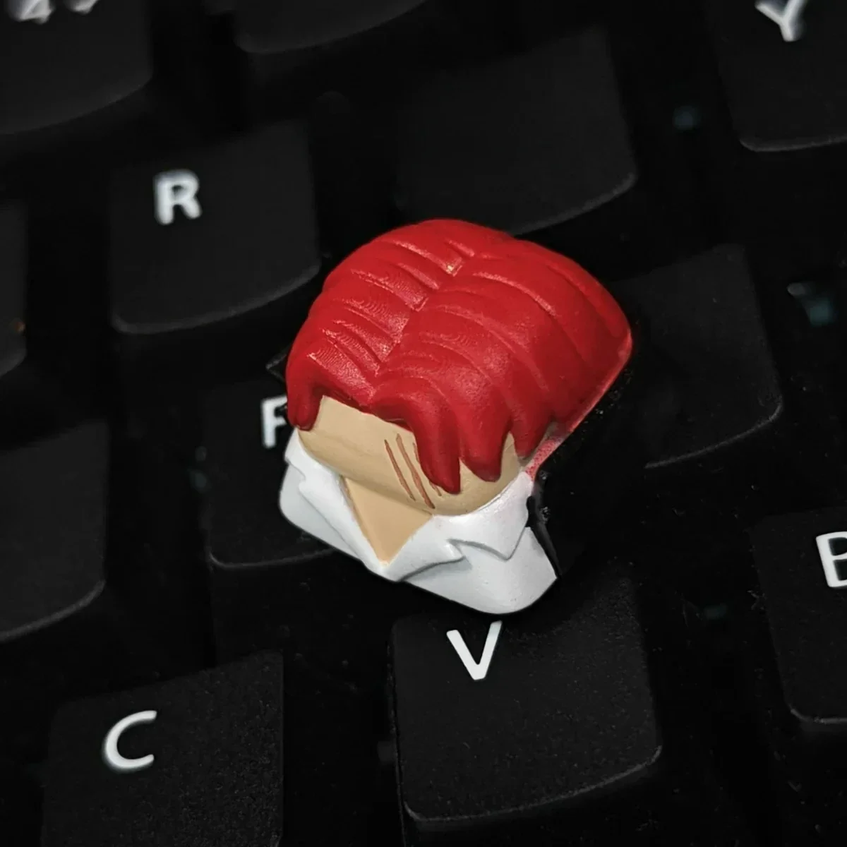 Premium handcrafted ONE PIECE Red-Haired Shanks artisan keycap, captured in a detailed close-up, highlighting the iconic character's intricate resin.