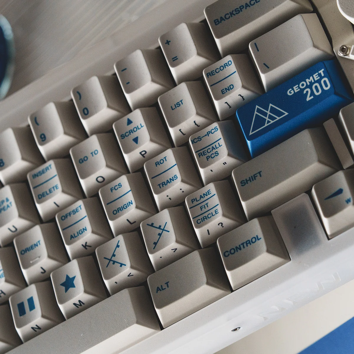 An artistic display of the distinctive Retro Geometric PBT Dye-Sub Keycap Set, showcasing classic patterns, vintage aesthetics, and a durable matte finish.