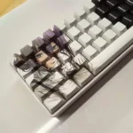 Exclusive Reze Chainsaw Man PBT dye-sub keycap set, showcasing vibrant character art from a unique angle, highlighting the explosive design.