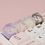 Whimsical rose bear artisan keycap, handcrafted from translucent pastel resin, displayed from a unique perspective to reveal its intricate details angle.