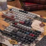 Sherlock Holmes PBT Dye-Sub keycaps set, shown from multiple angles, reveal their vintage detective aesthetic and intricate cipher book designs.