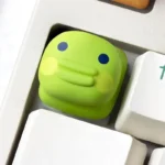 Tamagotchi artisan keycaps from various angles, showcasing vibrant pixel pet designs and charming handcrafted details on mechanical keyboard.