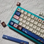 Authentic Tibetan Root Letter PBT Dye-Sub keycap set showcased from multiple angles, revealing vibrant calligraphy and serene Jataka motifs.