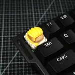 Premium artisan resin keycap featuring a detailed 3D sculpted Jett from Valorant, showcasing vibrant colors and a glossy finish for gamers.
