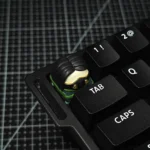 Detailed Sova Valorant agent artisan resin keycap, capturing the iconic character's essence with vibrant blue accents and glossy finish.