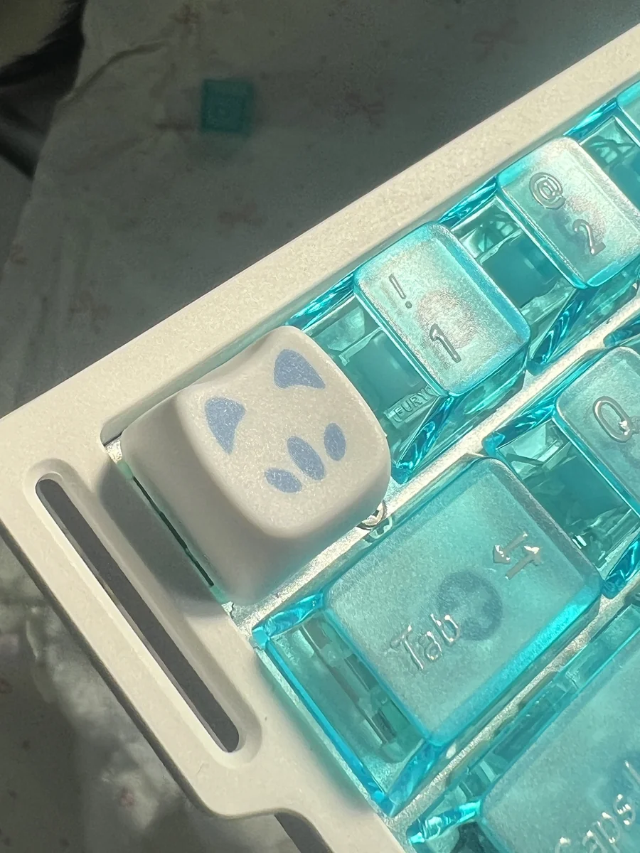 Explore a gallery of Valorant Omen Kitty PBT keycaps from various angles, highlighting the playful stylized cat design and sleek dark aesthetic.