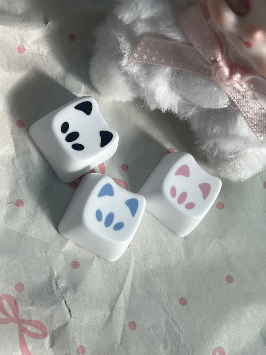 Playful gallery views of Valorant Omen Kitty PBT keycaps, highlighting their sleek design and intricate details from multiple angles.