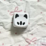 Playful Valorant Omen Kitty PBT keycaps, shown from various angles, highlighting their unique stylized design, dark sleek aesthetic.