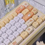Adorable Rilakkuma & Kaoru PBT Dye-Sub MOA keycap set, showcasing playful characters from various angles with cute pastel colors and charming detail.