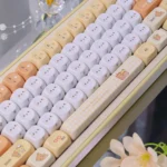 Adorable Rilakkuma and Kaoru PBT Dye-Sub MOA keycap, viewed from various angles, highlighting its whimsical pastel charm.