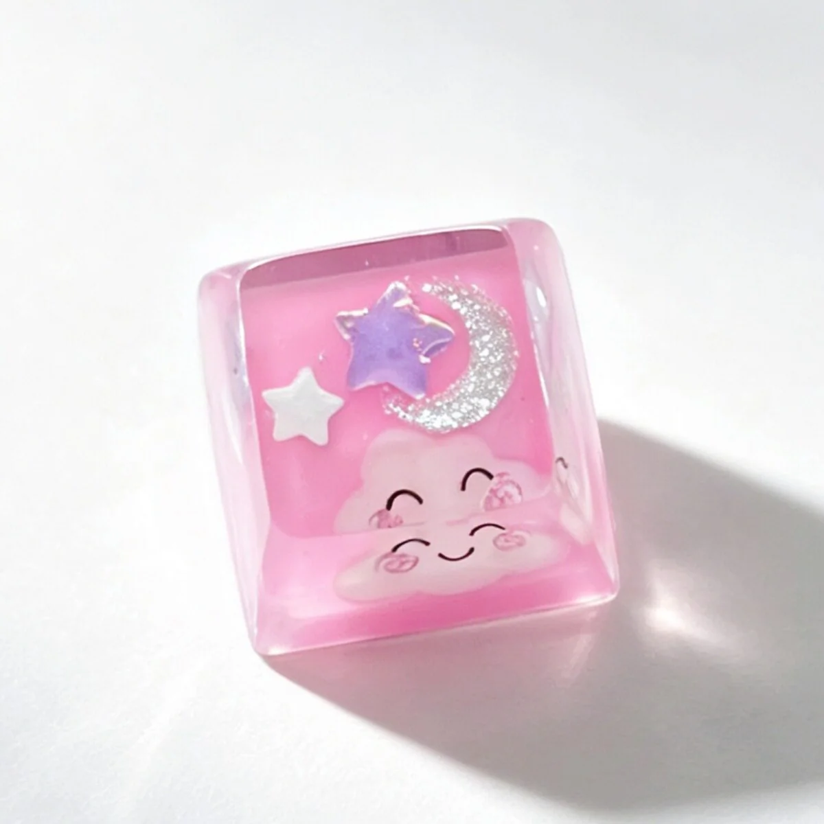 Handcrafted artisan cloud keycap, showcasing its dreamy 3D translucent resin and cheerful smiling expression from various angles.
