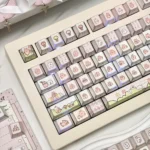 A full set of whimsical bunny PBT keycaps set featuring adorable ice cream designs, displayed from multiple playful angles.