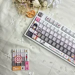 A collection of Cafe Stella and the Reaper's Butterflies Shiki Natsume PBT backlit keycaps, showcasing various angles with dreamy anime character art and soft.