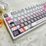 Cafe Stella and the Reaper's Butterflies Shiki Natsume PBT backlit keycaps set from multiple angles, highlighting dreamy anime character art, soft hues, and translucent legends.