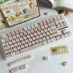 A charming close-up of the artisan caramel cat PBT MOA profile keycap, showcasing its whimsical handcrafted details and adorable feline design.