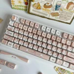 Close-up from a fresh angle of the adorable caramel cat PBT cat keycap, showcasing its playful, handcrafted details and warm, whimsical feline.