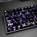 Angled view: Carbon Fiber Backlit PC keycaps. Sleek, glowing dark angel motifs. Premium, mysterious.