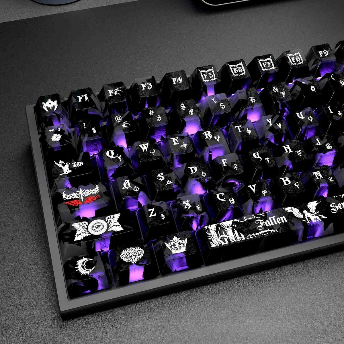 Angled view: Carbon Fiber Backlit PC keycaps. Sleek, glowing dark angel motifs. Premium, mysterious.