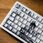 The Solitary Scholar Ceramic Keycap Set: luxurious tactile ceramic, subtle side-engraved legends. Refined minimalist aesthetic delivers a unique touch.