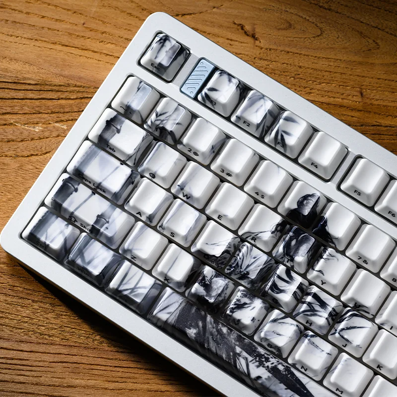 The Solitary Scholar Ceramic Keycap Set: luxurious tactile ceramic, subtle side-engraved legends. Refined minimalist aesthetic delivers a unique touch.