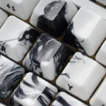 The Solitary Scholar Ceramic Keycap Set: luxurious, refined minimalist design. Tactile ceramic textures, subtle side-engraved legends for a unique touch.