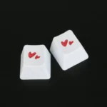 Premium Dual-Heart PBT Keycap gallery. Durable PBT and elegant romantic dual heart design shown from multiple angles, symbolizing connection.