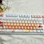 A collection of Charming Mahiru Shiina PBT backlit keycaps, presented from multiple angles to highlight their angelic design, premium finish.