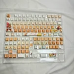 Premium Charming Mahiru Shiina PBT backlit keycaps. Gallery shows soft angelic aesthetics, luminous glow, and intricate character details from varied angles.