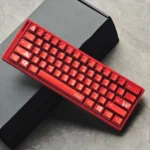 Detailed shot of Cola PBT keycaps, revealing their vibrant red and white retro metallic charm and durable dye-sub legends for mechanical keyboards.