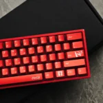 Cola PBT Keycaps in vibrant red and white, shown from different angles, highlighting their glossy retro metallic charm and durable dye-sub legends.