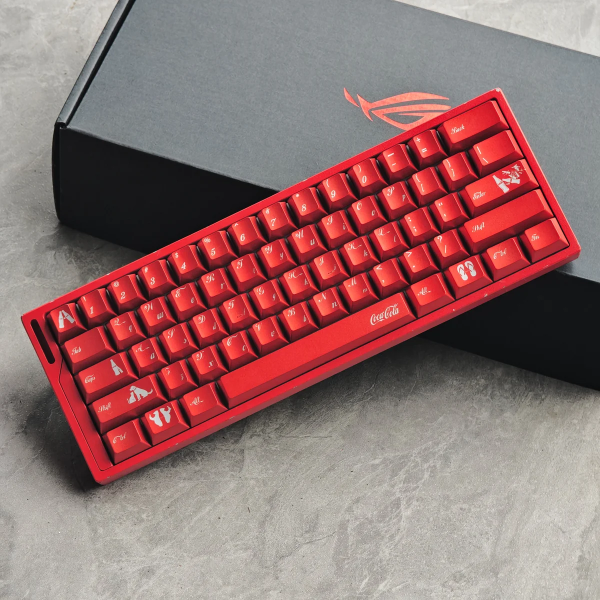 Iconic Cola PBT keycaps in vibrant red and white, featuring a glossy metallic finish and durable dye-sub legends for a retro mechanical keyboard.