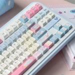 Playful Cowboy Sweetheart PBT Cherry keycaps in a whimsical blue and pink palette, showcasing their distinctive western-inspired design from a unique keycap.